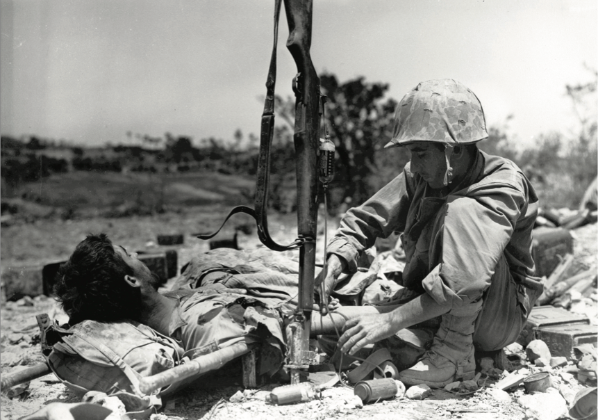 Wounded Marine gets injection of blood plasma from Navy Hospital Corpsman during battle for Okinawa, May 1945 (U.S. Marine Corps)